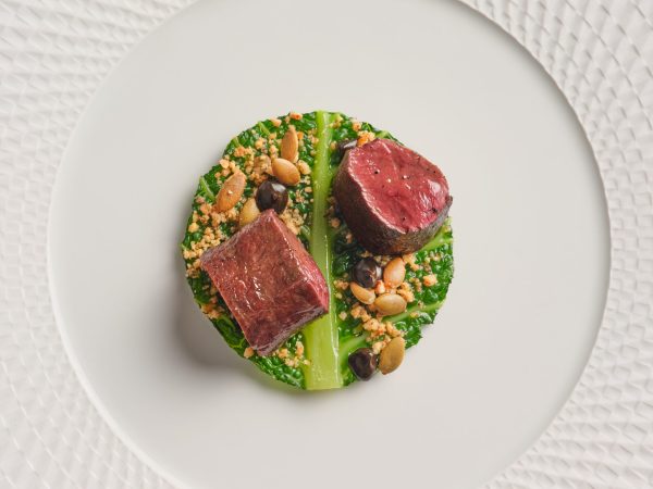 Seasonal meat main course with vegetables at Wild Honey St James