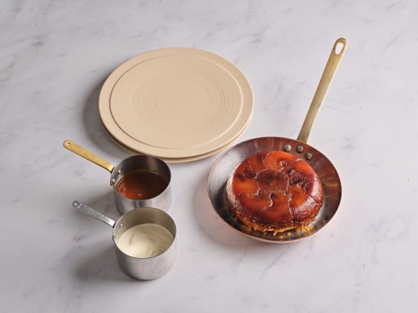 Tarte Tatin served with sauce and cream at Wild Honey St James